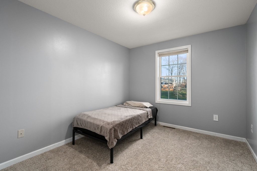 89 Jarvis Avenue Holyoke, MA 01040 - Photo 20 of 27 an empty room with a bed and a window