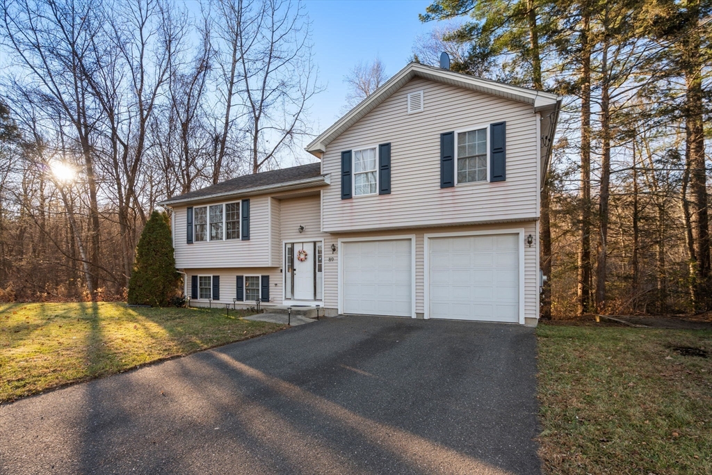 89 Jarvis Avenue Holyoke, MA 01040 - Photo 2 of 27 a view of a white house with a big yard and large trees