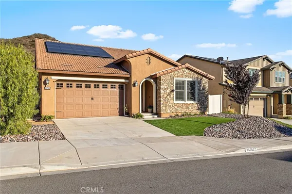 a view of a white house with a yard and plants