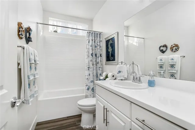 a bathroom with a sink mirror vanity and toilet