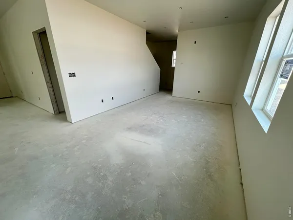 a kitchen with a table chairs refrigerator and microwave