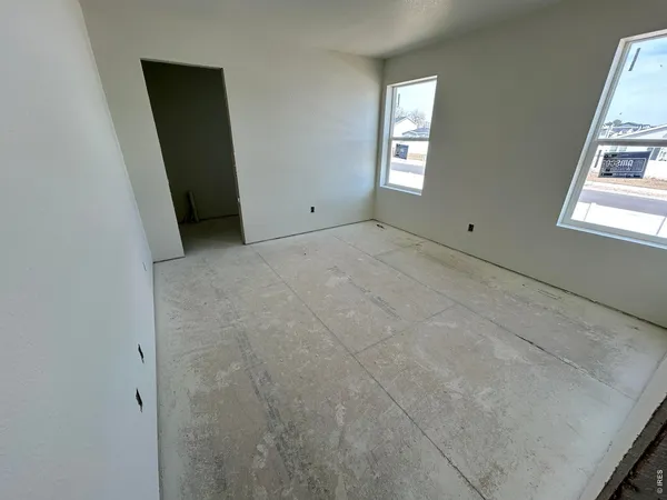 a kitchen with a dining table chairs and refrigerator