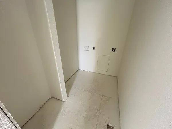 a view of hallway with furniture and wooden floor