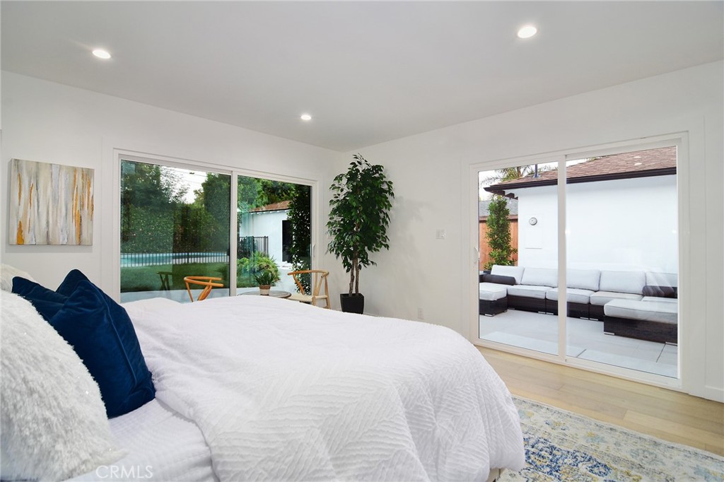 6118 Longridge Avenue Valley Glen, CA 91401 - Photo 27 of 42 a large bedroom with a large bed and large windows
