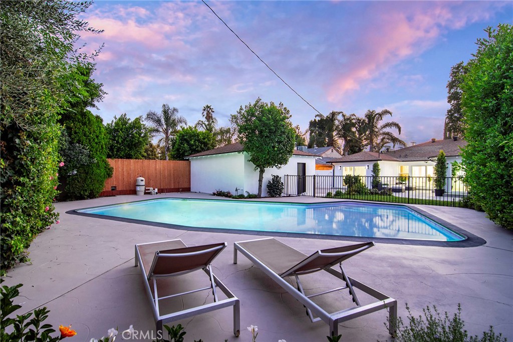 6118 Longridge Avenue Valley Glen, CA 91401 - Photo 32 of 42 a swimming pool with outdoor seating and yard in the back