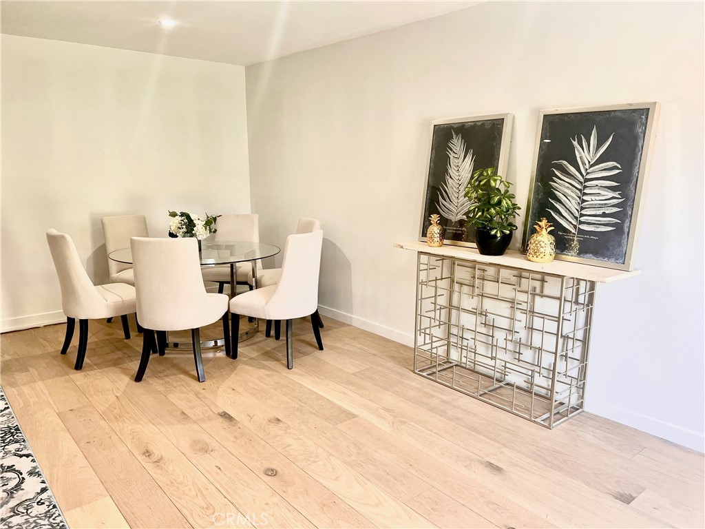 6118 Longridge Avenue Valley Glen, CA 91401 - Photo 40 of 42 a dining room with furniture and wooden floor