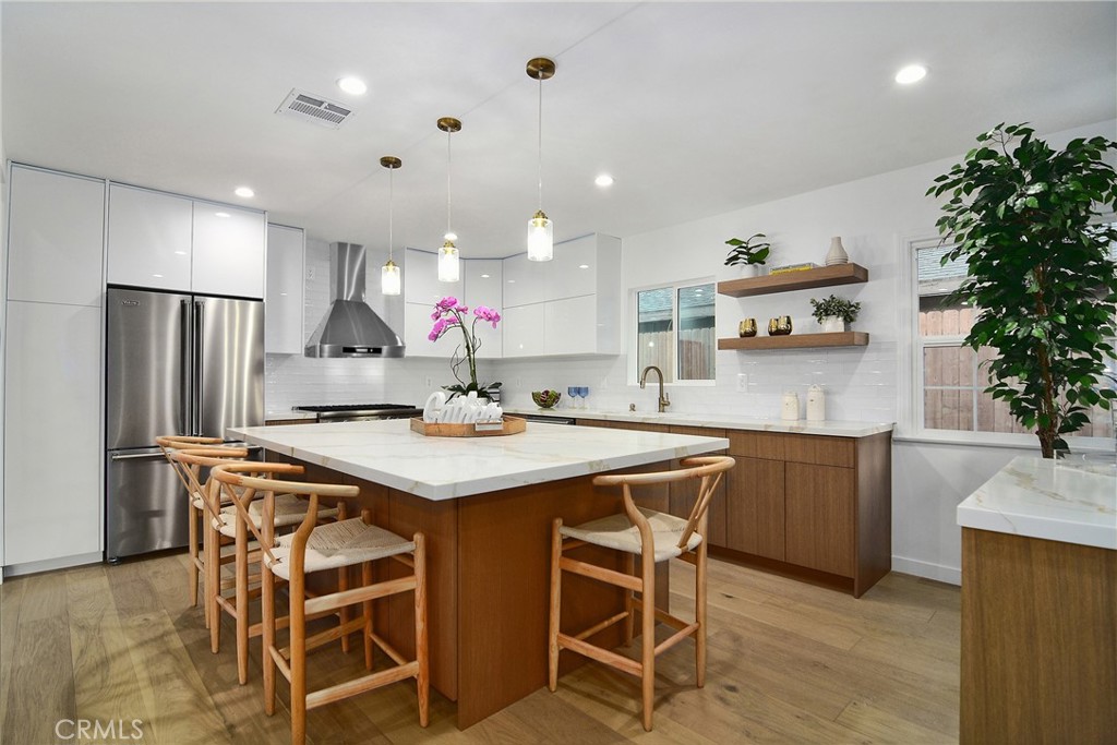 6118 Longridge Avenue Valley Glen, CA 91401 - Photo 7 of 42 a kitchen with kitchen island a sink stove and refrigerator