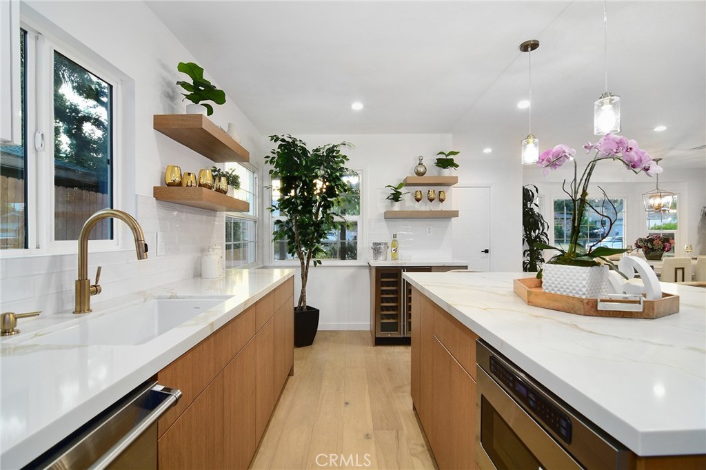6118 Longridge Avenue Valley Glen, CA 91401 - Photo 8 of 42 a kitchen with kitchen island granite countertop a sink and white cabinets