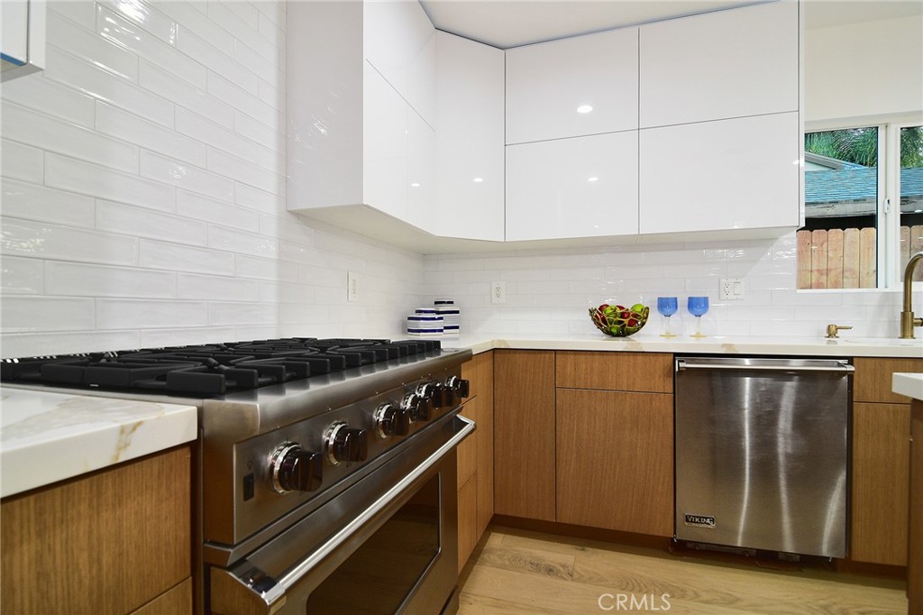 6118 Longridge Avenue Valley Glen, CA 91401 - Photo 9 of 42 a white stove top oven sitting inside of a kitchen