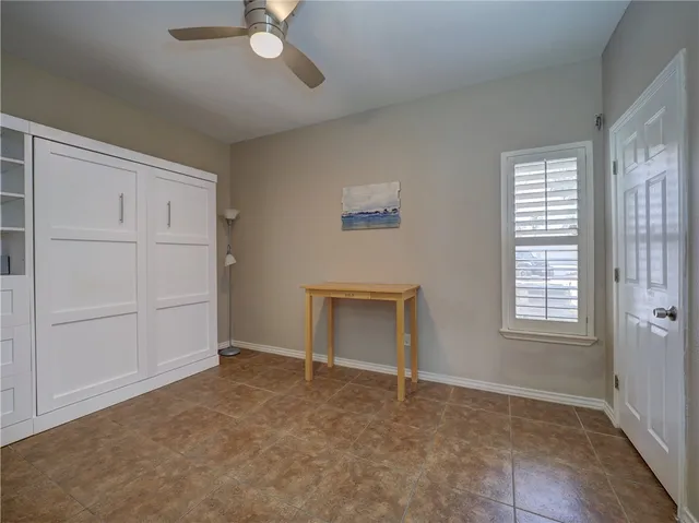 a view of an empty room with a fireplace and a window