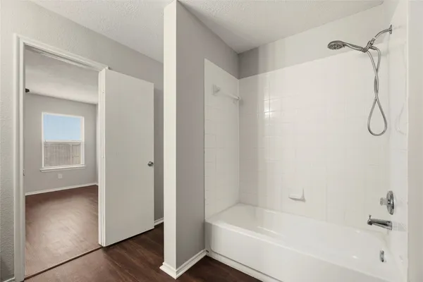 a bathroom with a bathtub and a shower