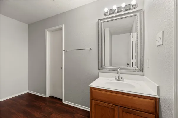 a bathroom with a sink a light fixture and a mirror