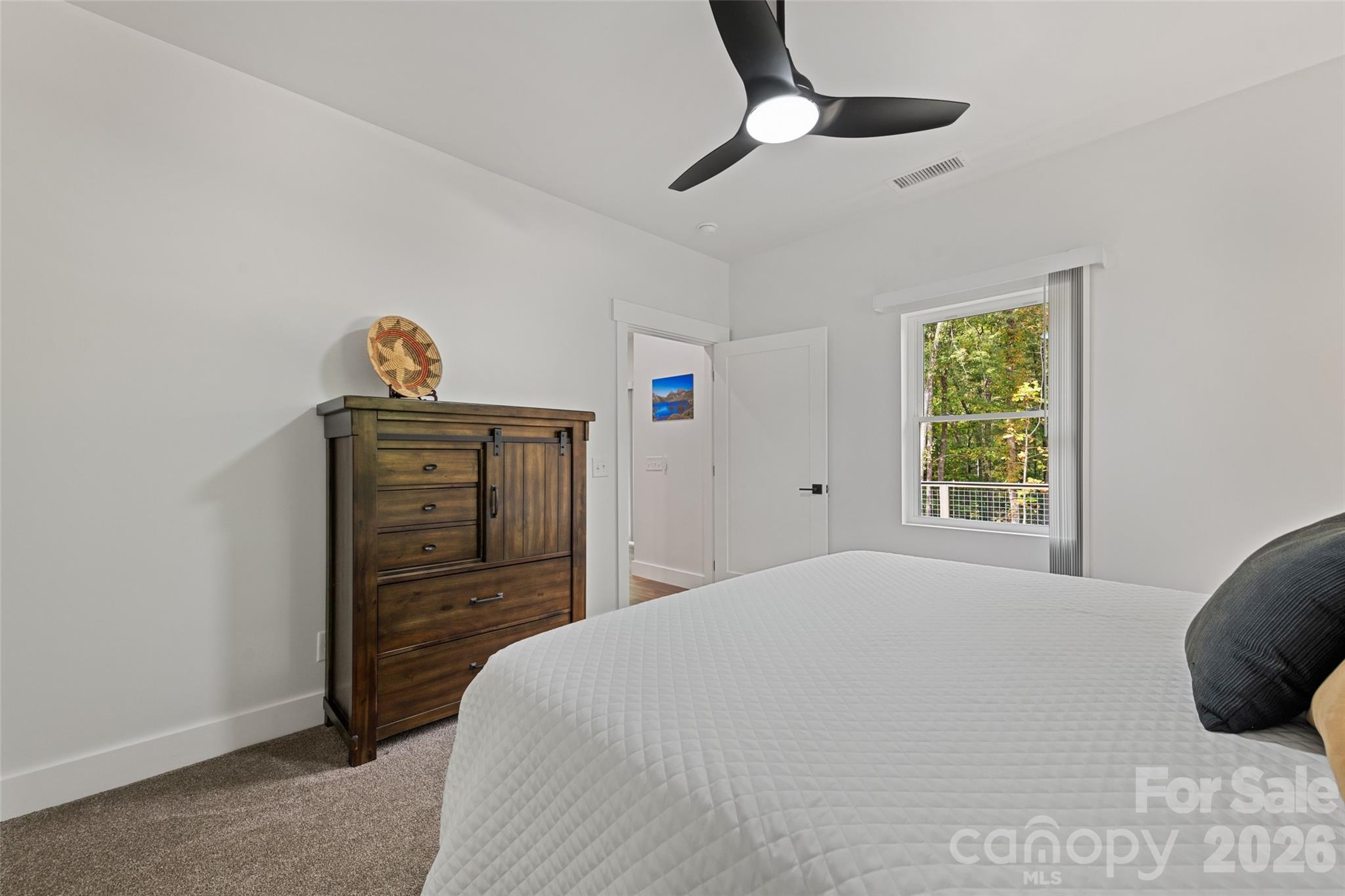 1185 Wallalieu Road Otto, NC 28763 - Photo 26 of 43 a bedroom with a bed and a window