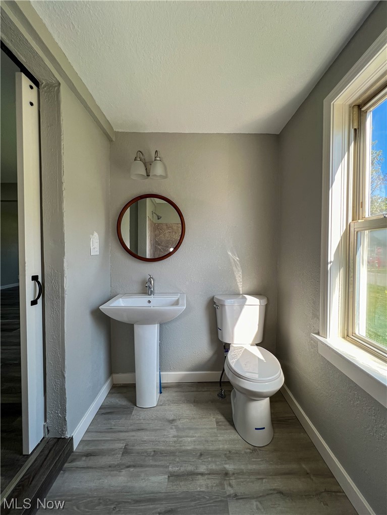 602 West Marshall Road McDonald, OH 44437 - Photo 18 of 19 Bathroom featuring a wealth of natural light, toilet, flooring, and sink