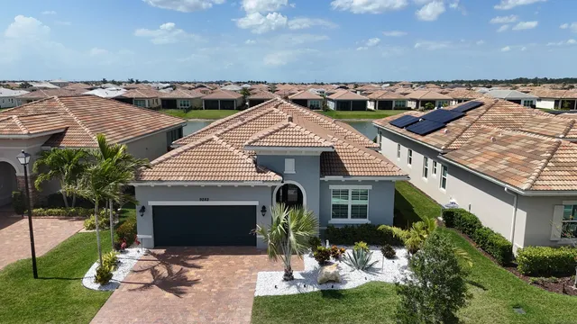 aerial view of a house with yard and potted plants
