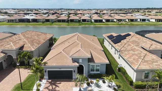 an aerial view of a house with a lake view
