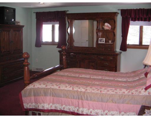 1 Taylor Road Maynard, MA 01754 - Photo 11 of 18 a bedroom with a bed and a dresser