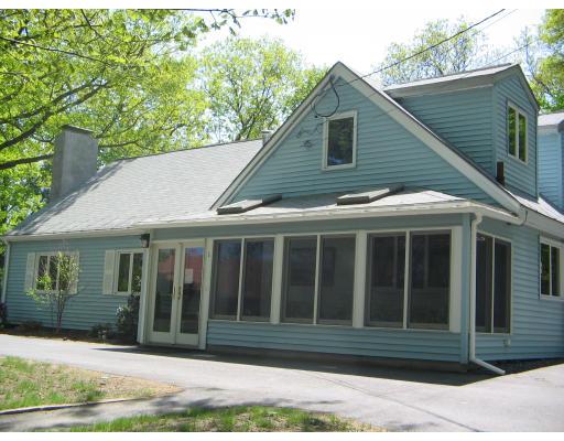 1 Taylor Road Maynard, MA 01754 - Photo 2 of 18 a view of brick house with a window plants and palm trees