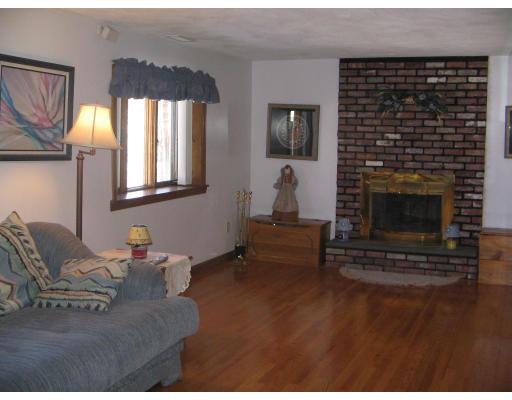 1 Taylor Road Maynard, MA 01754 - Photo 7 of 18 a living room with furniture a flat screen tv and a fireplace