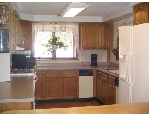 1 Taylor Road Maynard, MA 01754 - Photo 9 of 18 a kitchen with stainless steel appliances granite countertop a refrigerator a sink a stove and a microwave