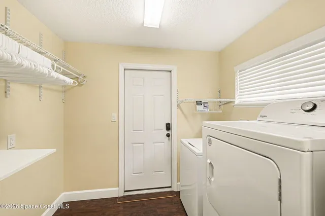 a view of a storage & utility room with dryer and washer