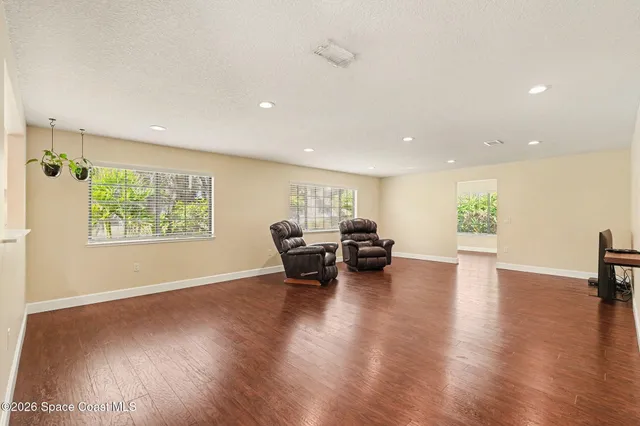 a view of a living room a dining room and wooden floor