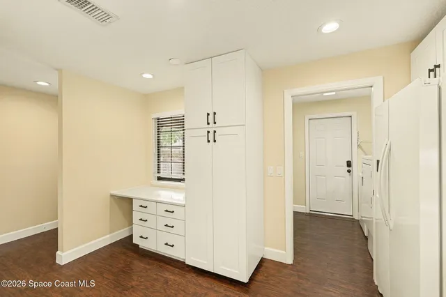 a view of walk in closet with wooden floor