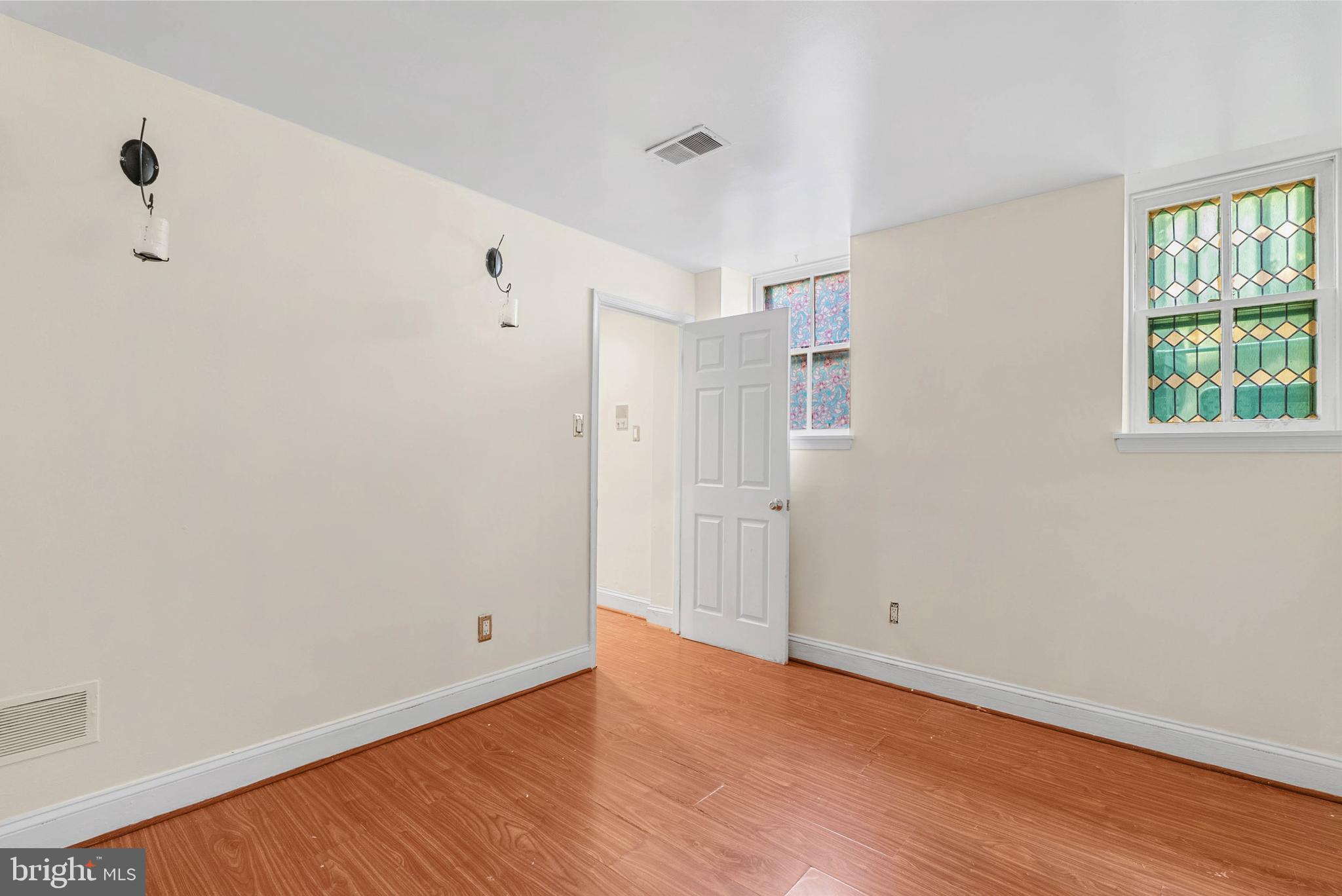 2024 Spring Garden Street, Unit 4 Philadelphia, PA 19130 - Photo 22 of 28 a view of an empty room with wooden floor and a window
