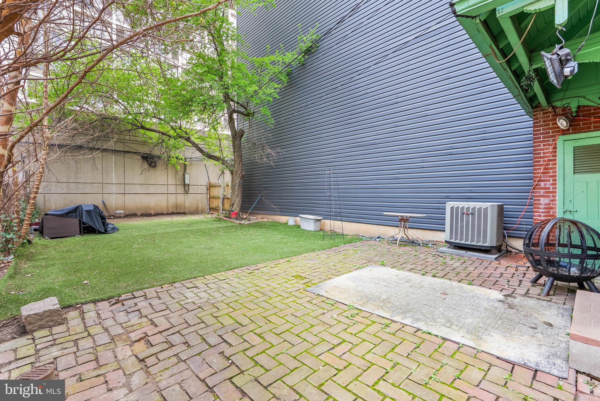 2024 Spring Garden Street, Unit 4 Philadelphia, PA 19130 - Photo 25 of 28 a backyard of a house with table and chairs