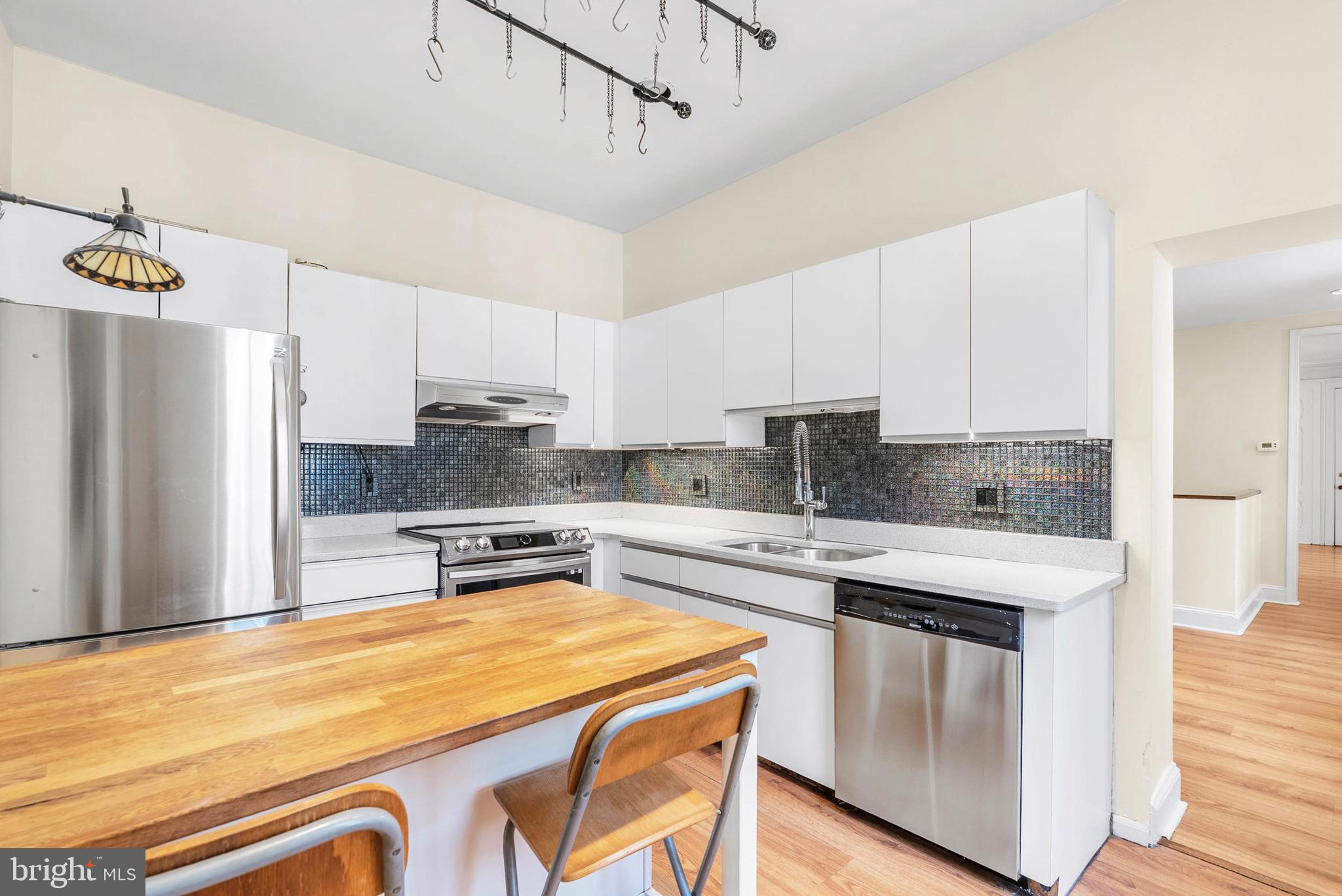 2024 Spring Garden Street, Unit 4 Philadelphia, PA 19130 - Photo 5 of 28 a kitchen with stainless steel appliances granite countertop a stove refrigerator sink and cabinets