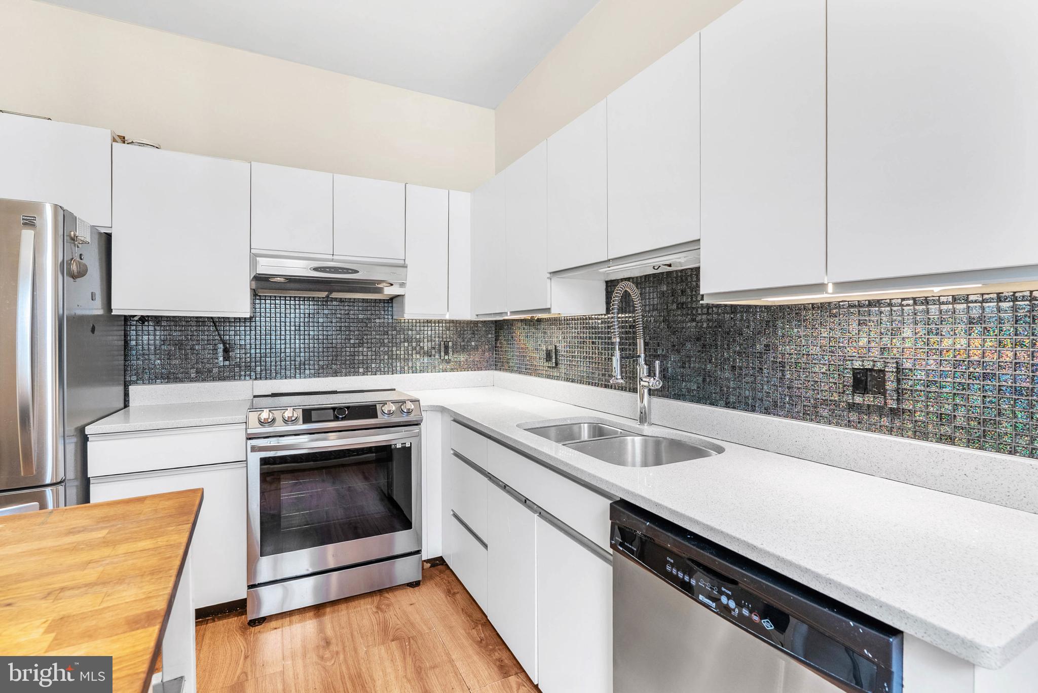 2024 Spring Garden Street, Unit 4 Philadelphia, PA 19130 - Photo 6 of 28 a kitchen with a sink stove and cabinets