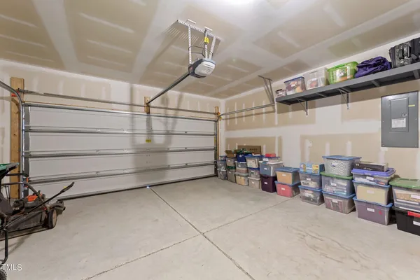 a utility room with dryer washer and a view of living room