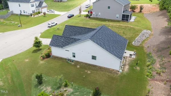 a view of backyard of house and yard