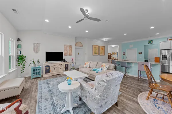 a kitchen with stainless steel appliances granite countertop a refrigerator and a stove top oven