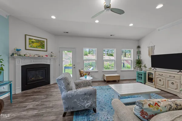 a living room with furniture fireplace and a table