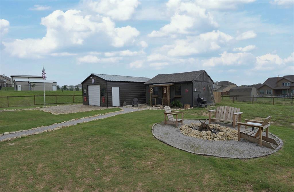 116 Spanish Moss Trail Rhome, TX 76078 - Photo 6 of 40 Backyard facing firepit, workshop & addtl' garage