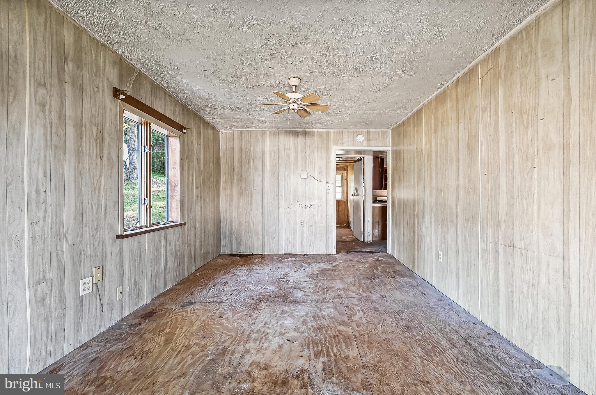 1211 Van Bibber Road Edgewood, MD 21040 - Photo 14 of 25 an empty room with chandelier fan and windows