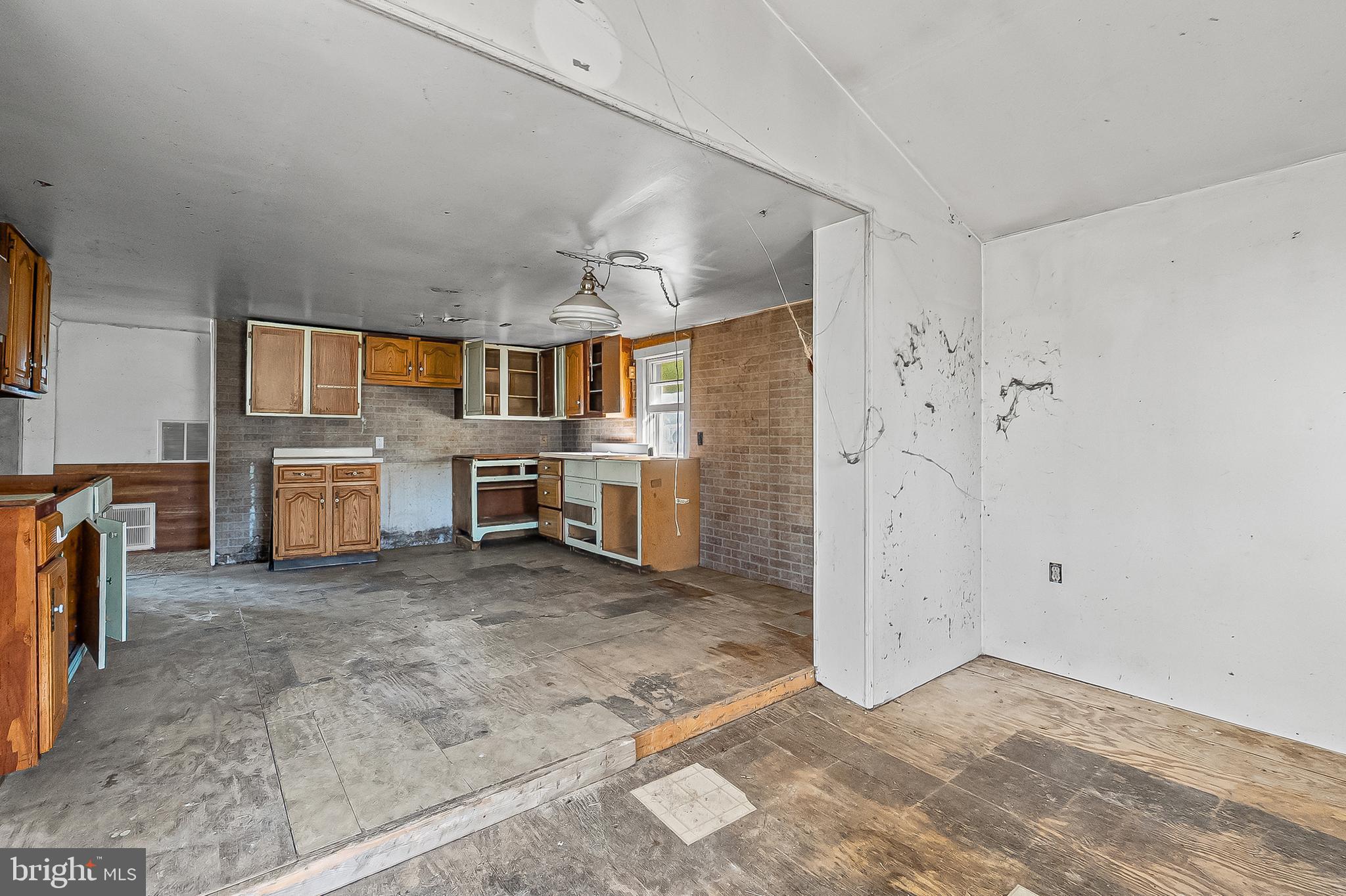 1211 Van Bibber Road Edgewood, MD 21040 - Photo 3 of 25 a view of a kitchen with a sink stove cabinets and empty room