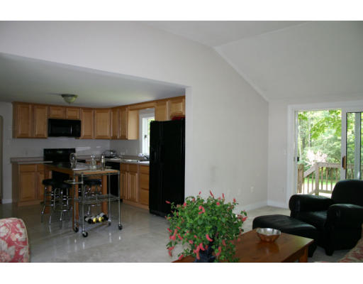 193 Oxbow Road Wayland, MA 01778 - Photo 8 of 20 a living room with furniture a flat screen tv and a window