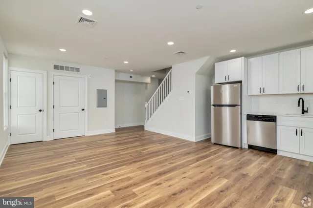 a view of kitchen with stainless steel appliances refrigerator oven and cabinets