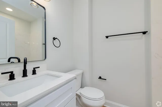 a bathroom with a sink toilet and vanity
