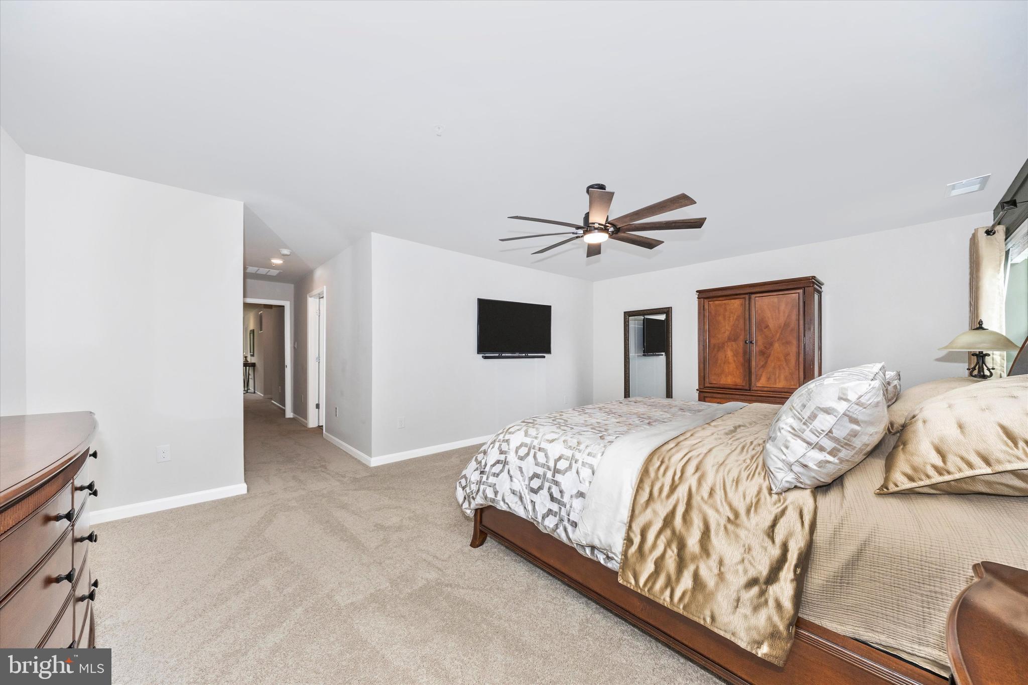 700 Bond Street Frederick, MD 21701 - Photo 19 of 49 a bedroom with a large bed and a ceiling fan