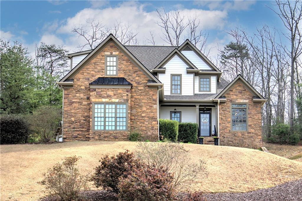 a front view of a house with a yard and garage