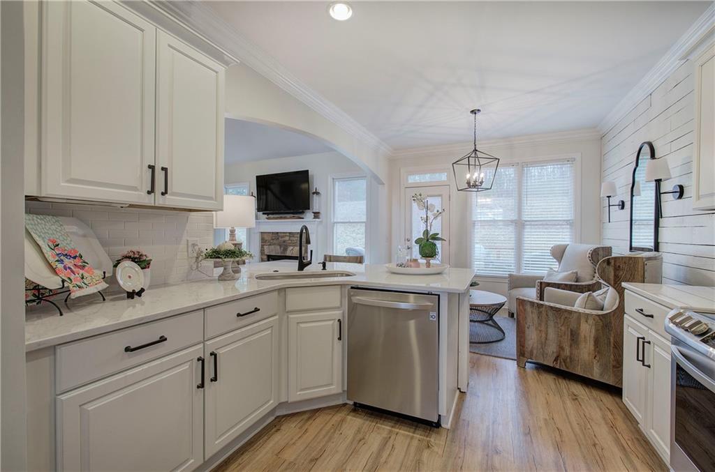 16 Thunderhawk Lane Rydal, GA 30171 - Photo 11 of 37 a kitchen with stainless steel appliances granite countertop a sink dishwasher a stove and white cabinets with wooden floor