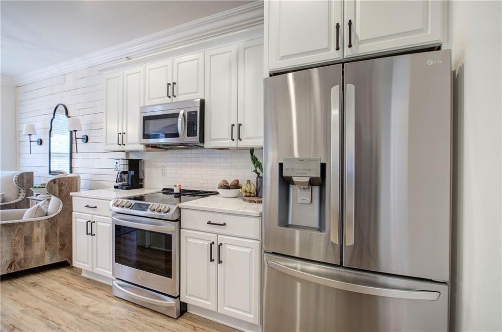 16 Thunderhawk Lane Rydal, GA 30171 - Photo 12 of 37 a kitchen with stainless steel appliances a refrigerator sink and microwave