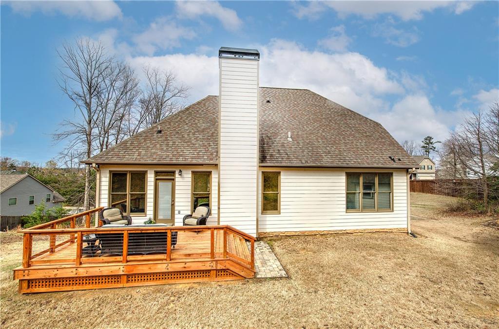 16 Thunderhawk Lane Rydal, GA 30171 - Photo 33 of 37 a backyard of a house with large trees and barbeque oven