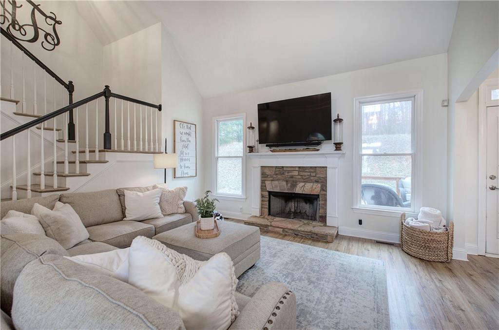 16 Thunderhawk Lane Rydal, GA 30171 - Photo 7 of 37 a living room with furniture a flat screen tv and a fireplace