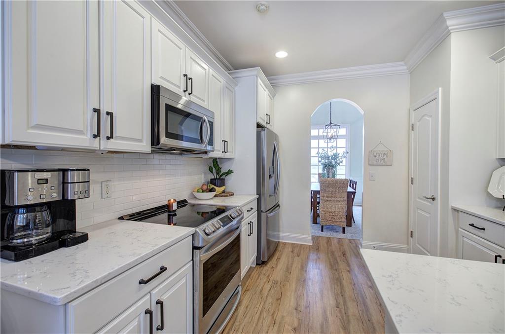 16 Thunderhawk Lane Rydal, GA 30171 - Photo 10 of 37 a kitchen with stainless steel appliances kitchen island granite countertop a stove a sink and a microwave