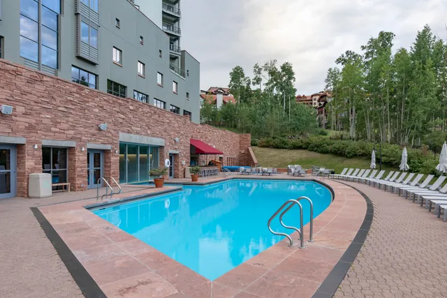 swimming pool with outdoor seating and yard