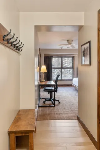 a living room with furniture a rug and a floor to ceiling window